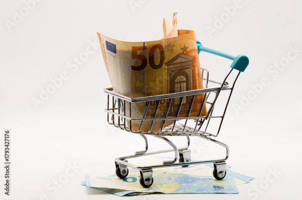 Obraz Miniature Shopping Cart Overflowing with Euro Banknotes (50) and Scattered Currency Below