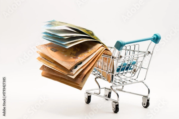Obraz Dynamic Cash Flow: Multiple Fanned Euro Banknotes Displayed in a Tiny Shopping Cart, Symbolizing Market Movement