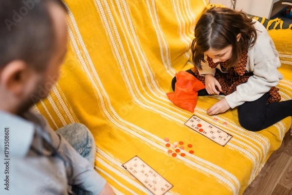 Fototapeta Happy father and child playing board game at home - happiness and family concept.