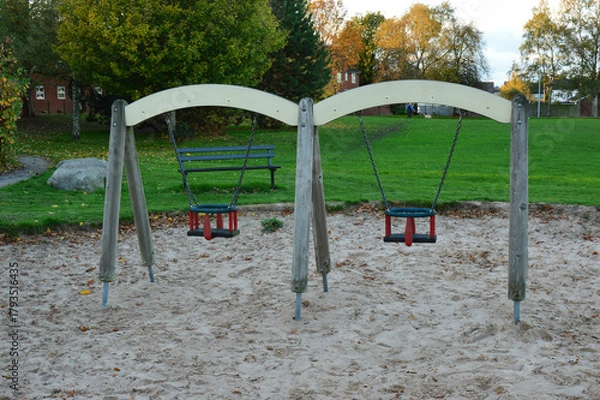 Fototapeta Playground Swings in Autumn Park with Sandpit and Trees