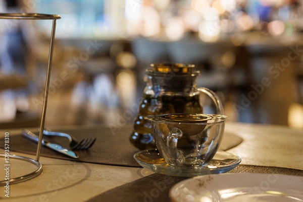 Fototapeta Elegant tea setting in a cozy cafe during a quiet afternoon