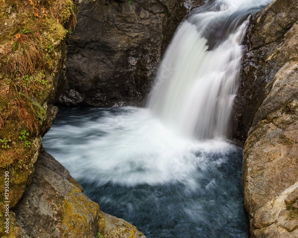 Fototapeta Close up mountain waterfall fast rushing water.