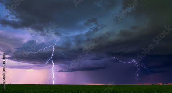 Fototapeta A dramatic lightning bolt illuminates dark storm clouds as turbulent weather intensifies rapidly overhead