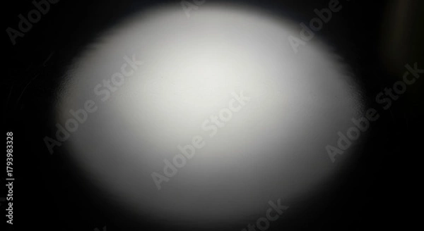 Fototapeta A soft, outoffocus spotlight illuminates a dark background