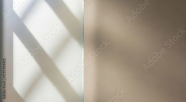 Fototapeta Geometric shadow patterns cast by sunlight on a wall, creating abstract shapes and lines