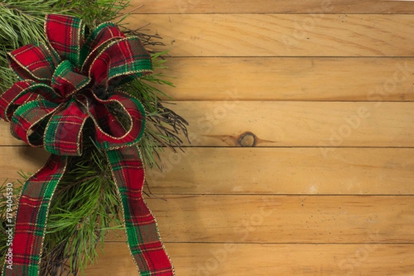 Obraz Bow on wreath with wood background