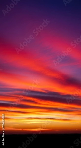 Fototapeta Vibrant twilight spectacle featuring intensely colored clouds stretching across a vast, fiery horizon line at dusk, Sunset, dramatic, beam