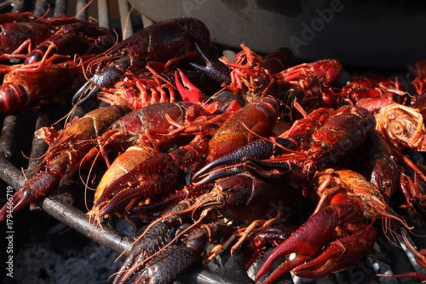 Fototapeta Fried crayfish in a cast-iron skillet over the fire