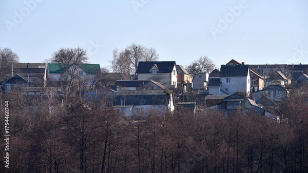Fototapeta house in nature, in a rural area. a country house for recreation. landscape, nature. traditional green and brown roofs of houses in the rural area of the during autumn or fall. park near the house