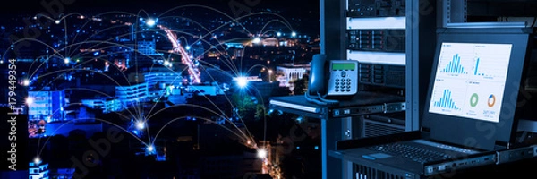 Fototapeta Management and monitoring monitor in data center and connectivity lines over night city background, smart city concept