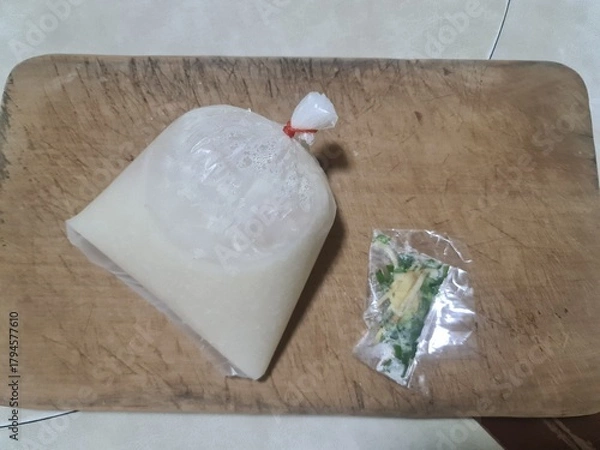 Fototapeta  minced pork porridge for breakfast in plastic bag Thai style with ginger and green spring onion isolated on wood board