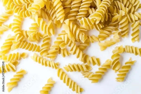 Fototapeta A delightful arrangement of raw fusilli pasta spirals on a clean white background, symbolizing the joys of cooking and the diversity of Italian cuisine aesthetics.