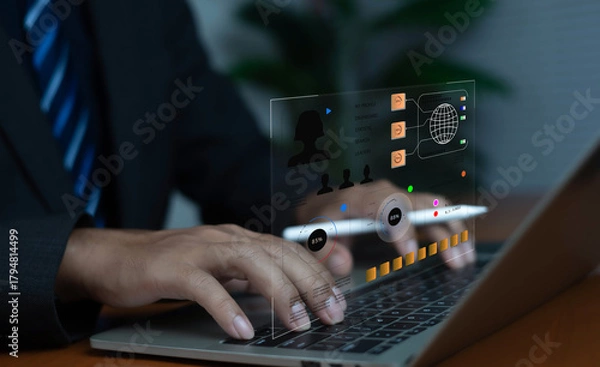 Obraz Businessman working on laptop with futuristic digital dashboard interface, representing data analytics, technology management, cybersecurity, and modern business innovation in the digital era.