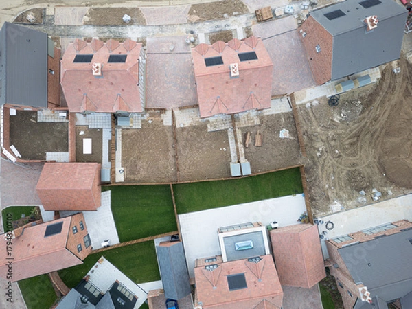 Obraz Drone top down view of a mixture of both affordable semi detached new homes and larger, detached family homes on a UK housing development project.