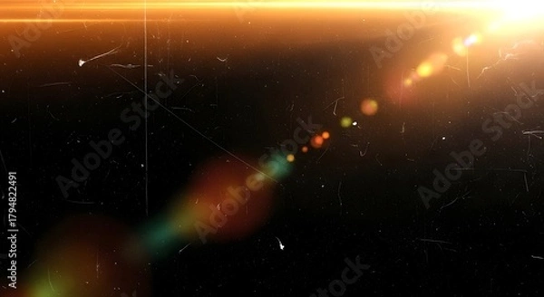 Fototapeta Abstract lens flare and light leak effect with dust particles on a dark background, cinematic and vintage feel