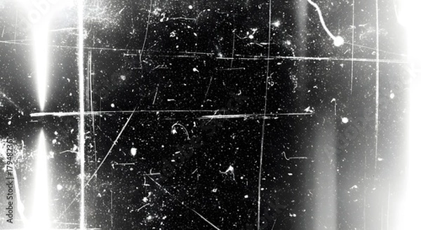 Fototapeta Abstract grunge texture with scratches and dust particles on a black background, creating a vintage or distressed film effect with bright light flares on the side