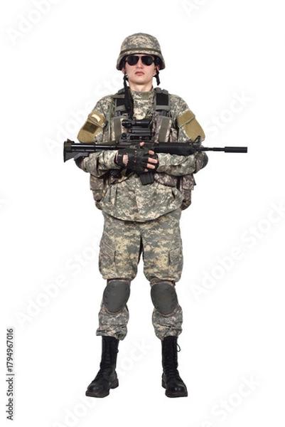 Fototapeta Man stands at full height  in an American soldier's uniform holds a rifle