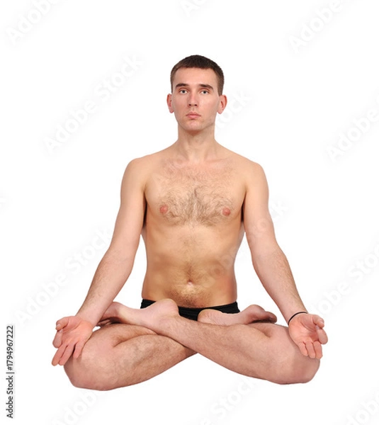 Fototapeta Man practicing yoga in the lotus position.
