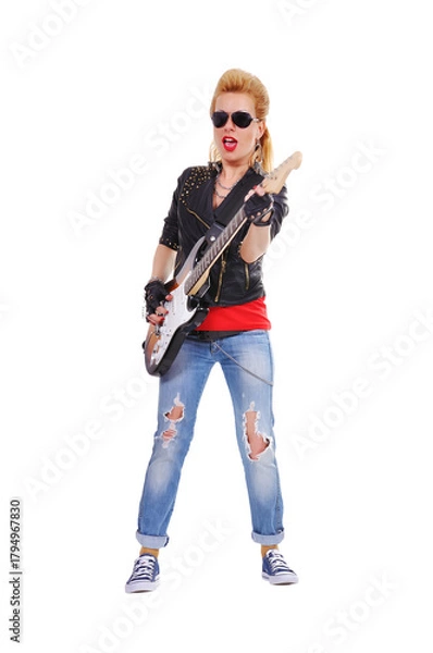 Fototapeta A rocker girl in a leather jacket expressively plays the guitar