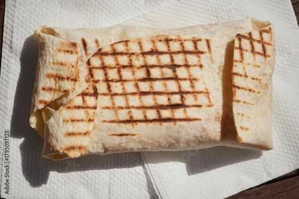 Obraz A French Tacos, a popular European fast food, filled with chicken and cheese