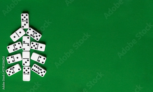 Fototapeta Christmas tree made of domino bones on green background with copy space