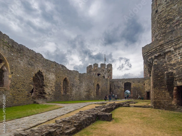 Fototapeta The ancient stone foundations of former buildings in the Outer Ward of a Welsh castle (Conwy, Wales, United Kingdom)