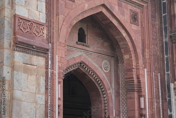 Fototapeta Vertical Closeup of Mughal Sandstone Arch with Decorative Carvings