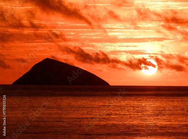 Obraz Fiery Sunset over a Distant Island Silhouette