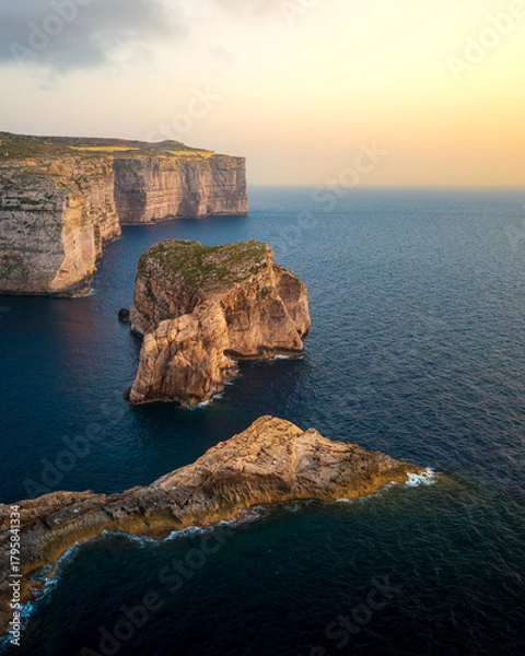 Fototapeta View of stunning cliffs and coastal scenery along the shores of Gozo in Malta during sunset
