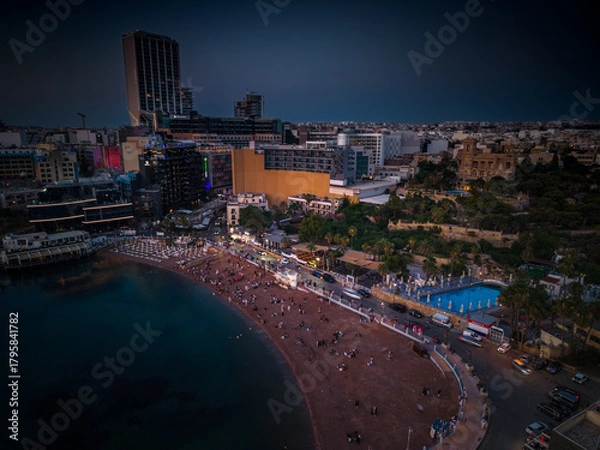 Obraz Nighttime view of vibrant Paceville beach in Malta filled with people enjoying the evening