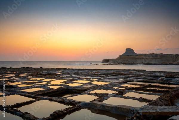 Obraz Sunrise over Malta salt pans with reflections and tranquil waters