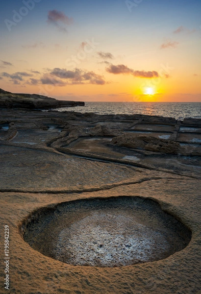 Obraz Beautiful sunset over rocky shore with round tide pool in the foreground