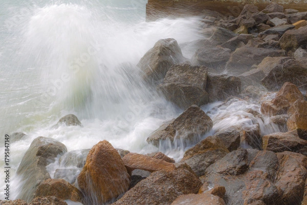 Obraz Ocean waves crashing against rocks on the shore
