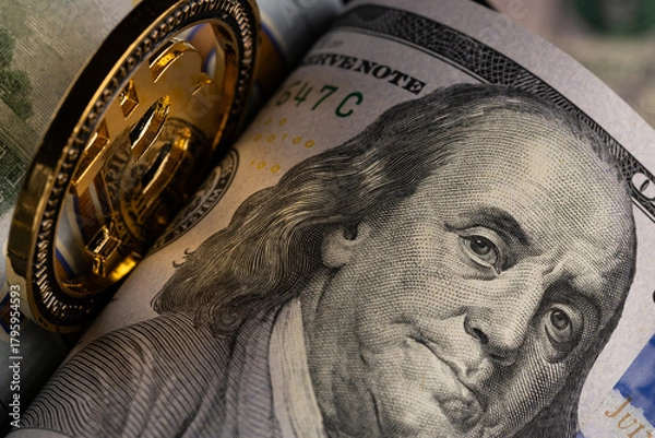 Fototapeta Physical Gold Bitcoin Coin Standing on Stack of US One Hundred Dollar Bills