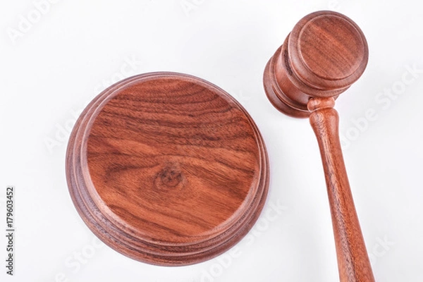 Fototapeta Wooden judge gavel and wooden stand. Judge gavel and stand isolated on white background.