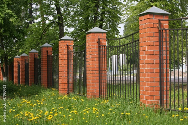 Obraz High fence with brick columns
