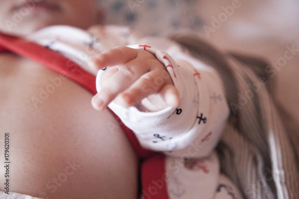Obraz little baby hand, tummy and belly button in the bed
