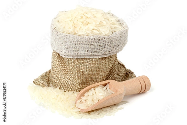 Fototapeta Rice in a jute sack with a wooden spoon to scoop it. isolated on white background.