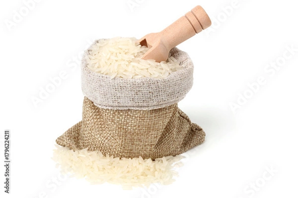 Fototapeta Rice in a jute sack with a wooden spoon to scoop it up. isolated on white background.