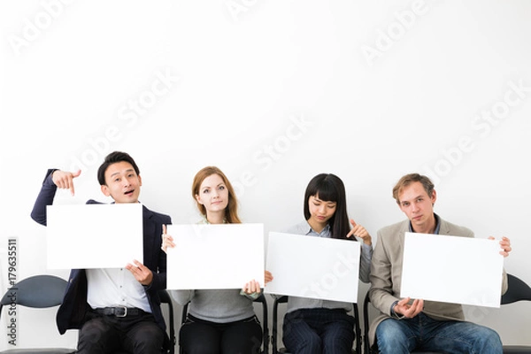 Fototapeta Group of people showing white boards.