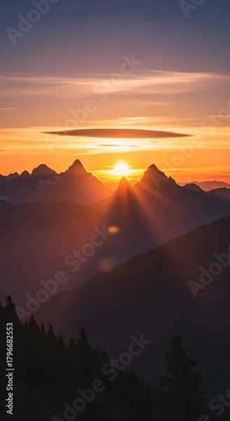 Fototapeta A breathtaking view of a sunset over a mountain range with vibrant colors illuminating the sky and creating a serene atmosphere
