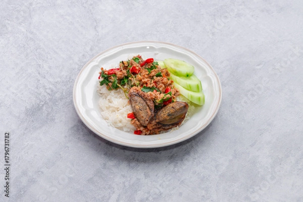 Fototapeta Thai food stir fried with spicy curry paste With different kinds of meat topped on cooked rice