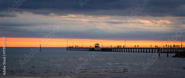 Fototapeta Mordialloc pier near Melbourne Australia at sunset with golden sky and clouds .