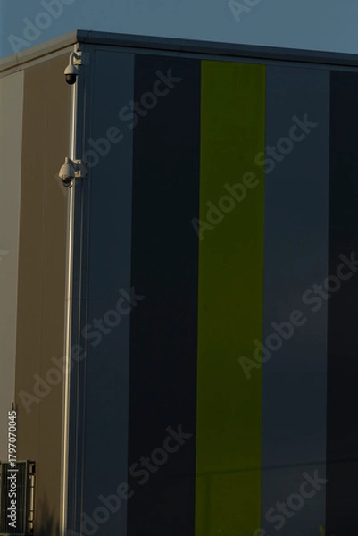 Fototapeta A modern industrial structure featuring bold vertical color stripes, capturing contemporary architecture aesthetics.