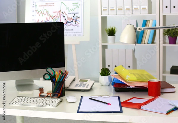 Fototapeta Office table with blank notepad and laptop
