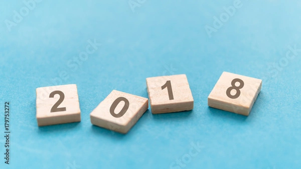 Fototapeta 2018 word in wooden block on blue background, blur and select focus