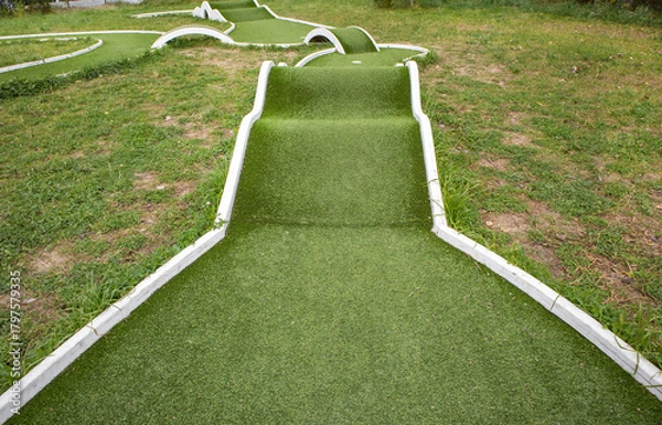 Fototapeta Mini golf hole with artificial turf and obstacles family fun horizontal