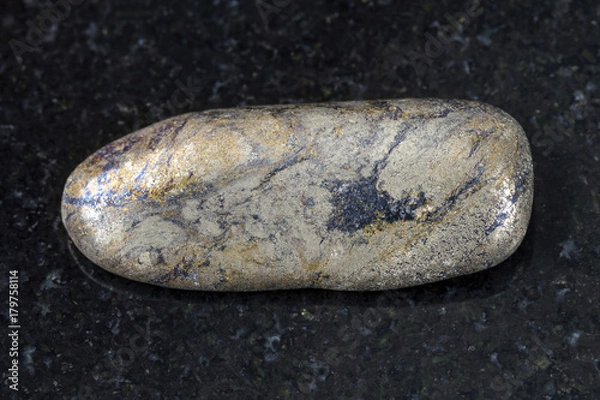 Fototapeta pebble of Arsenopyrite stone on dark background