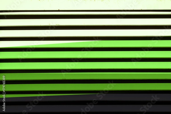 Fototapeta Colored roller shutter with dark gray, green and light green mood