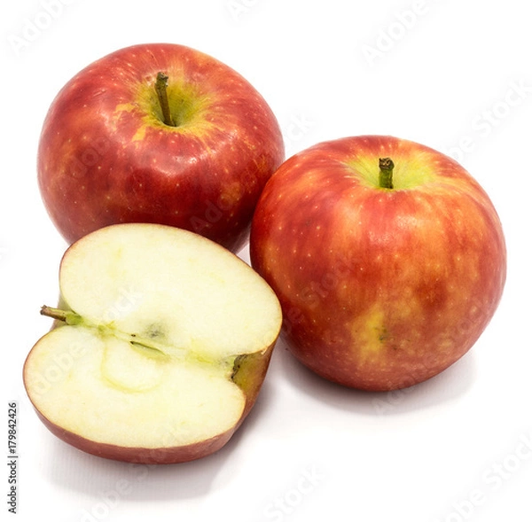 Fototapeta Red Kanzi apples, two whole, one half, isolated on white background